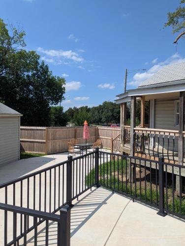 a woman walking on a fence next to a house at Zoobilee-on Zoo Blvd in Wichita
