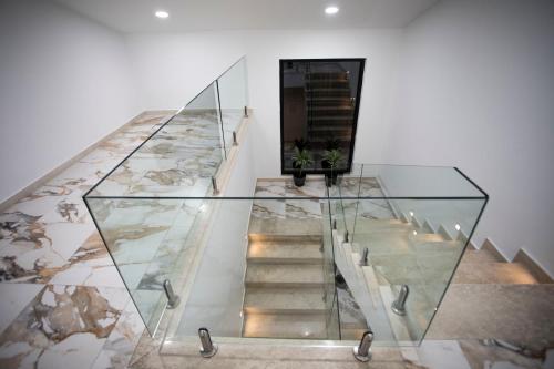 a glass staircase in a building with a glass floor at Villa Klaus Center Hotel in Tirana
