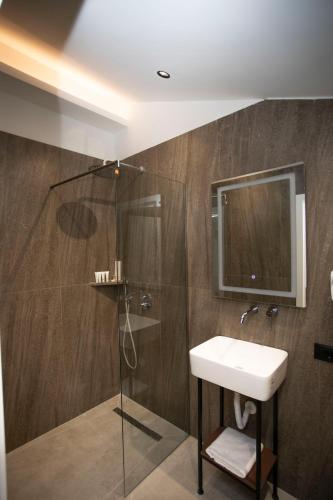 a bathroom with a sink and a shower at Villa Klaus Center Hotel in Tirana