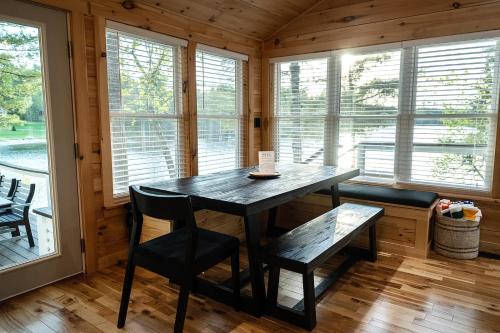 a dining room with a table and chairs and windows at Tri-Lake Escape in Naples