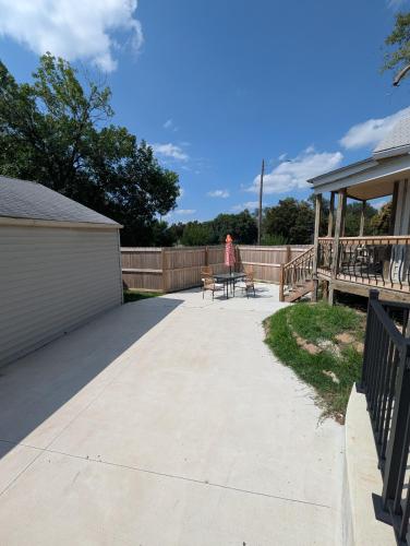a woman standing on a patio in a backyard at Zoobilee-on Zoo Blvd in Wichita