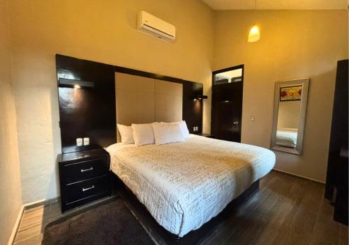 a bedroom with a large bed with a white bedspread at Hotel Real Campestre Tepetoci in Tepexi del Río