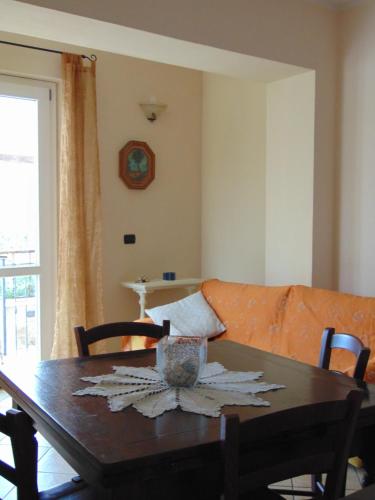 a dining room with a table and a couch at Appartamenti Ca'Melia in Sarzana