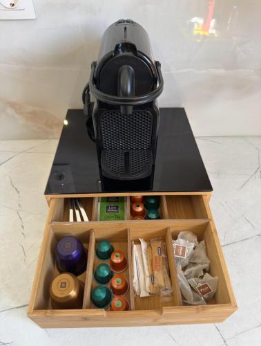 a coffee maker sitting on top of a table at LaLaLa Cosy Studio in Koutsourás
