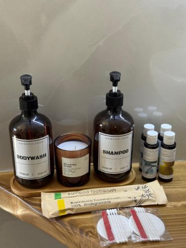two bottles of soap and a candle on a table at LaLaLa Cosy Studio in Koutsourás