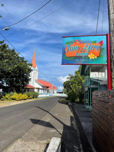 a sign for a hawaiian beer store on a street at Tiva Here Lodge Tahaa in Tahaa