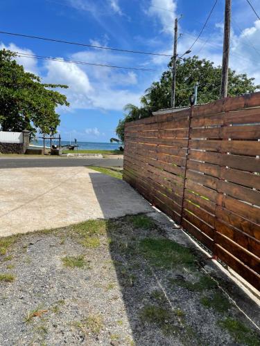 a brick fence with the ocean in the background at Tiva Here Lodge Tahaa in Tahaa