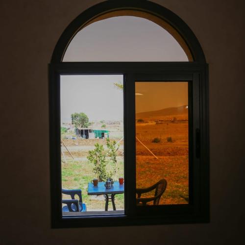 a window looking out at a table with a view of a field at ZEN 4 Rooms 8 Beds Near Marrakesh 