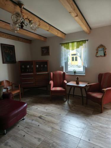 a living room with chairs and a table and a window at Penzion u Bohdy in Jaroslavice