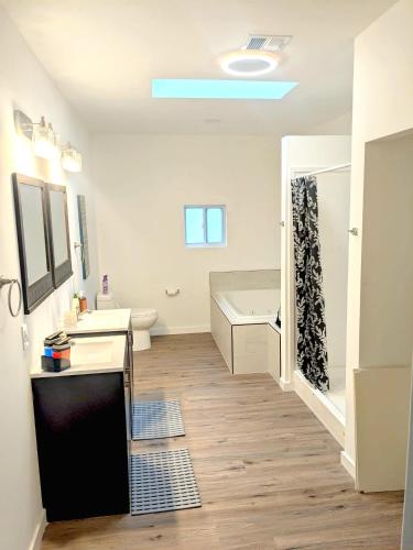 a bathroom with a tub and a sink and a shower at Cozy Guesthouse in Catasauqua