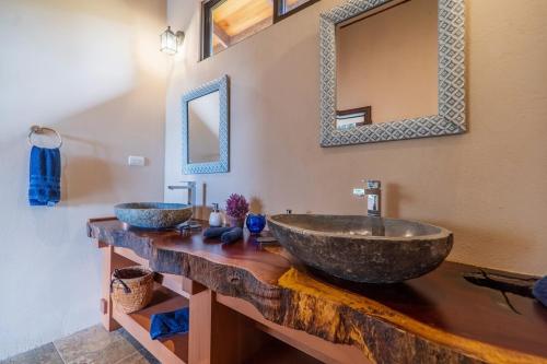 a bathroom with two sinks and a mirror at Getaway & Ocean Breeze - Secluded & Natural Charming - 2 bedrooms in Barú