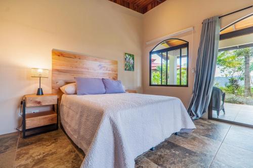 a bedroom with a large bed and a window at Getaway & Ocean Breeze - Secluded & Natural Charming - 2 bedrooms in Barú