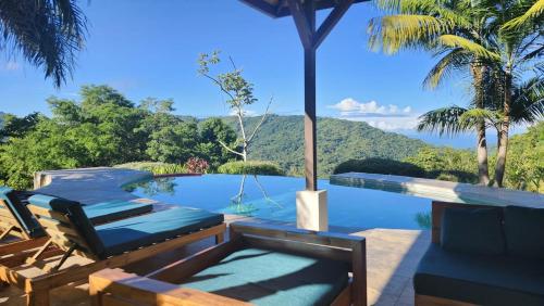 a swimming pool with a view of a mountain at Getaway & Ocean Breeze - Secluded & Natural Charming - 2 bedrooms in Barú