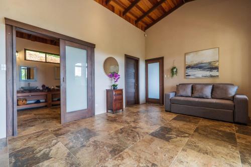 a living room with a couch and a table at Getaway & Ocean Breeze - Secluded & Natural Charming - 2 bedrooms in Barú
