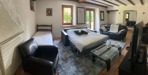 a living room with a bed and a couch and chairs at Spacious Farmhouse Apartment, by Lake & Mountains in Larringes