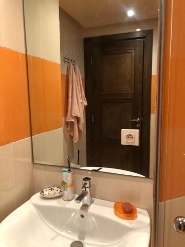 a bathroom with a sink and a mirror at Apartment Galia Mohammedia in Mohammedia
