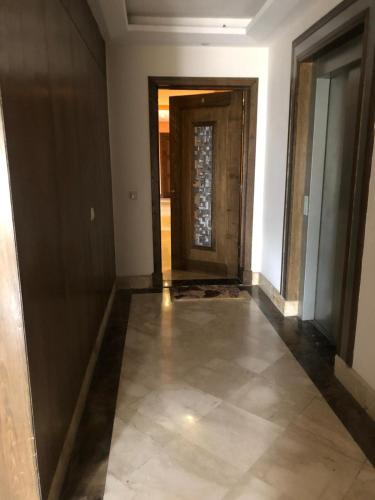 a hallway with a door and a tile floor at Apartment Galia Mohammedia in Mohammedia