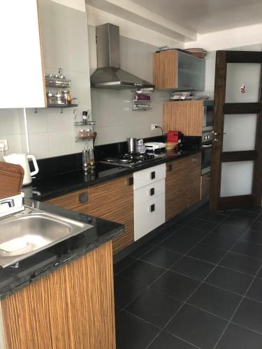 a kitchen with a sink and a counter top at Apartment Galia Mohammedia in Mohammedia