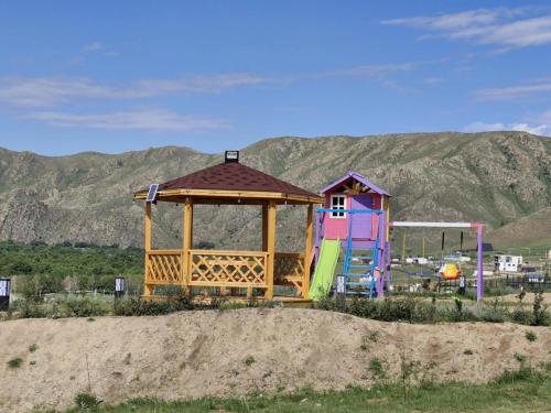 a playground with a gazebo and a house at Bright Terelj Family Camp in Dugang Süme