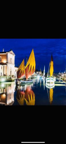 a group of boats in the water at night at Piccolo Da Vinci 17 in Cesenatico