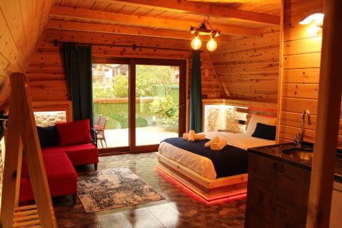 a bedroom with a bed and a sink in a cabin at ELASYA BUNGALOV in Rize