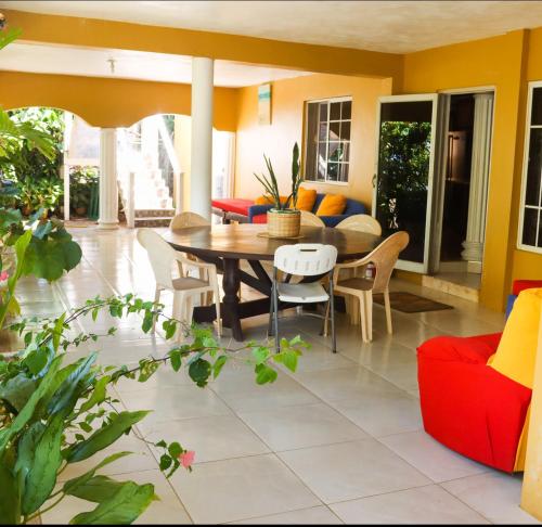 a living room with a table and chairs at Villa Del Mar in Black River