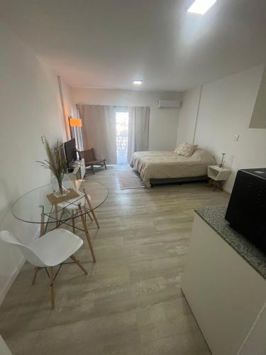 a bedroom with a bed and a desk and a table at L&M Suite Monoambiente in Belén de Escobar