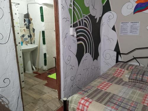 a small room with a bed in a bathroom at Posada del Valle in San Agustín de Valle Fértil