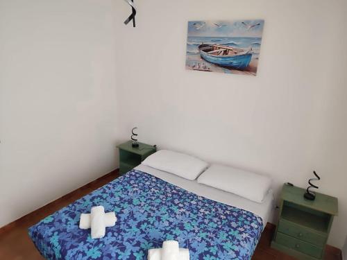 a bedroom with a bed with two crosses on it at Family & Friends - First floor - South West wing - Fully equipped with view - 15 minutes drive by car to the seaside in Galtellì
