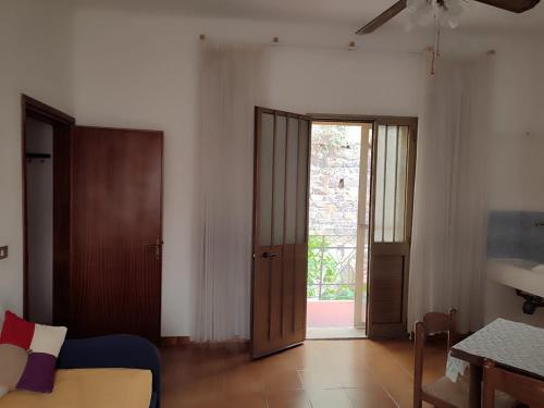a room with a bed and a door with a table at Family & Friends - First floor - South West wing - Fully equipped with view - 15 minutes drive by car to the seaside in Galtellì