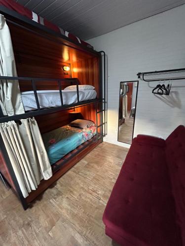 a room with two bunk beds and a mirror at Casa Victour, localização privilegiada in Bonito