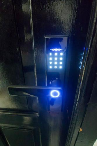 a blue light on the side of a door at Central Abu Dhabi Private Room in Abu Dhabi