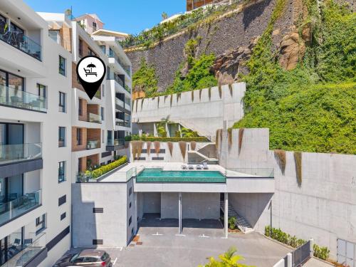 an apartment building with a swimming pool in the middle at MK Apart I in Funchal