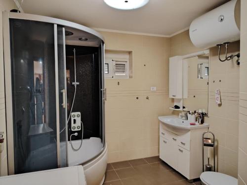 a bathroom with a shower and a sink at Simple Stay in Buljarica