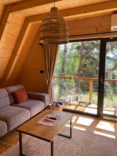 a living room with a couch and a table at Molika Forest House in Kolašin