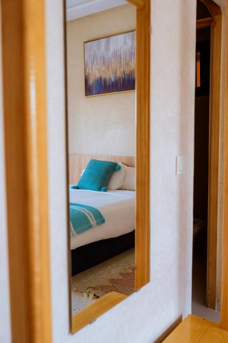 a mirror reflection of a bed in a bedroom at The Ocean Surf Villa in Dakhla