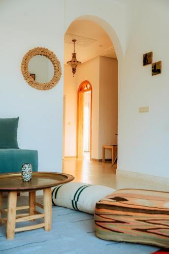 a living room with a blue couch and a table at The Ocean Surf Villa in Dakhla