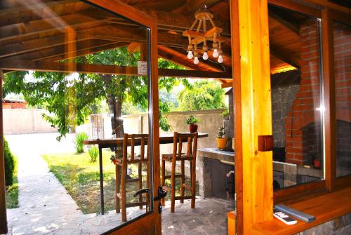 a screened in porch with a table and chairs at Къщи БРИК вила 2 in Sapareva Banya