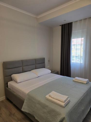 a bedroom with a bed with two towels on it at Fraj Holiday Homes Pogradec in Pogradec