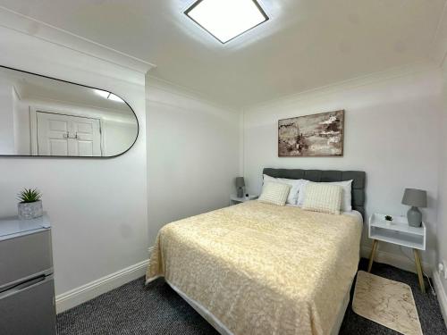 a bedroom with a bed and a mirror at Madrid Double Room in London