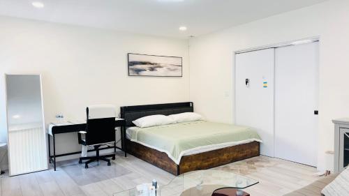 a bedroom with a bed and a desk in it at Line&Light 