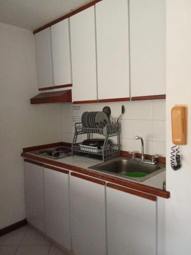 a kitchen with white cabinets and a sink at PARAJISO en Costa Azul in Porlamar