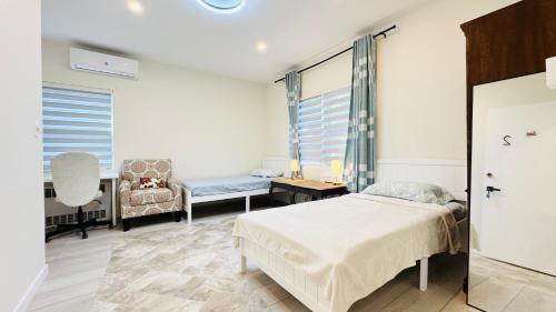 a bedroom with a bed and a couch and a chair at Line&Light