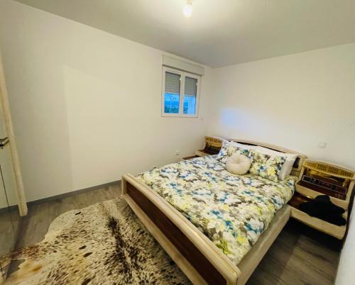 a bedroom with a bed and a window at Maison 3 Donasete T2 in Vieille-Brioude