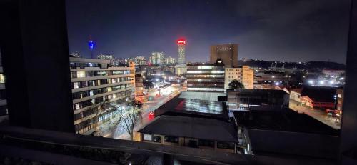 a view of a city at night with buildings at Secure Designer Jozi Apartment With Balcony & Ellis Park Views - Hallmark House in Johannesburg