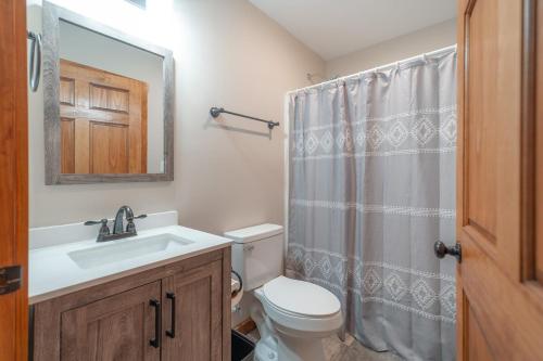 a bathroom with a sink and a toilet and a mirror at Sunset Cabin Privacy, Views, HotTub, Firepit, BBQ, Pets in Rileyville