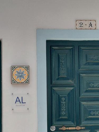a green door and a sign on a wall at Villa Sesta in Vila de Frades
