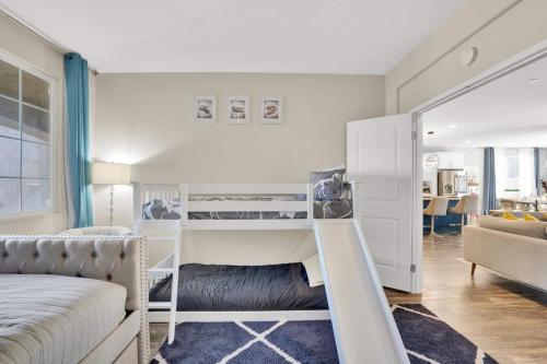 a bedroom with two bunk beds and a living room at 5br3b Pool, 2mi To Fstvals, Ev Chrgr, Gym, Games in Indio