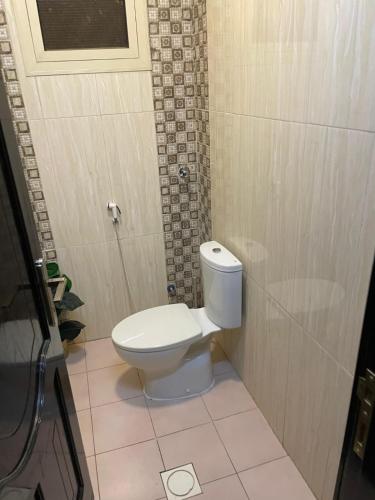 a bathroom with a white toilet in a stall at وحدات طيبة in Medina