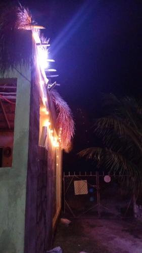 a street light on the side of a building at night at Cabañas Puertas del Sol in Telchac